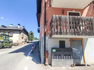 a building with a balcony on the side of a street at Apartment Ciasa Tella by Interhome in Moena