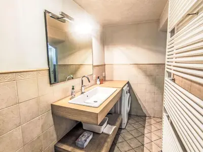 a bathroom with a sink and a mirror at Apartment Ciasa Tella by Interhome in Moena