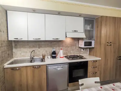 a kitchen with white cabinets and a sink at Apartment Ciasa Tella by Interhome in Moena