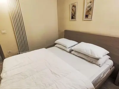 a bedroom with a bed with two pillows on it at Apartment Ciasa Tella by Interhome in Moena
