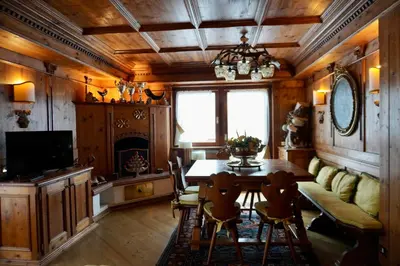 a dining room with a table and a fireplace at Alverà Luxury apartment - centro Cortina d'Ampezzo in Cortina dʼAmpezzo