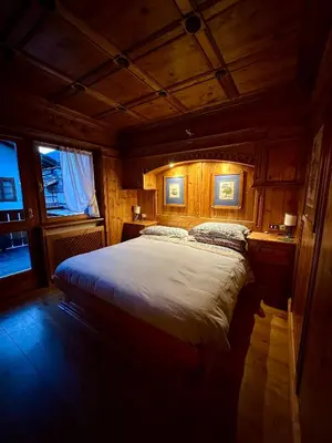 a bedroom with a large bed in a room at Alverà Luxury apartment - centro Cortina d'Ampezzo in Cortina dʼAmpezzo
