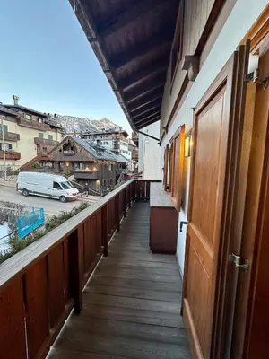a balcony of a building with a view of a street at Alverà Luxury apartment - centro Cortina d'Ampezzo in Cortina dʼAmpezzo