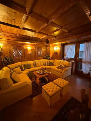 a large living room with couches and a table at Alverà Luxury apartment - centro Cortina d'Ampezzo in Cortina dʼAmpezzo