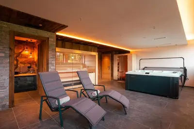 a room with chairs and a table and a tub at Ferienhaus Morx Puite in Moso