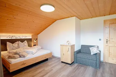 a bedroom with a bed and a chair at Ferienhaus Morx Puite in Moso