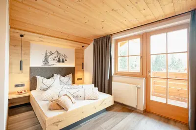 a bedroom with a bed in a room with wooden ceilings at Ferienhaus Morx Puite in Moso