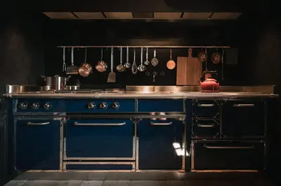 a kitchen with a stove and a blue counter top at South Tyrol Lodge With Mountain Views in Villandro