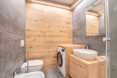 a bathroom with a sink and a washing machine at Ruoibes 17 in San Vito di Cadore