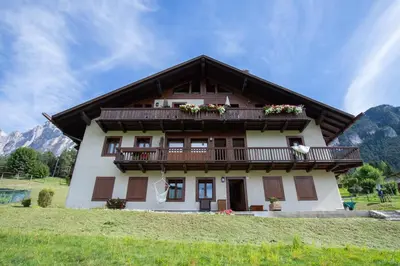 a house with a balcony on top of it at Ruoibes 17 in San Vito di Cadore
