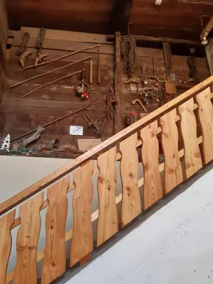 a wooden railing in a room with a floor at BeB LA STUBE DEI PARTEL in Ziano di Fiemme