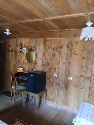a room with a table and a mirror on the wall at BeB LA STUBE DEI PARTEL in Ziano di Fiemme
