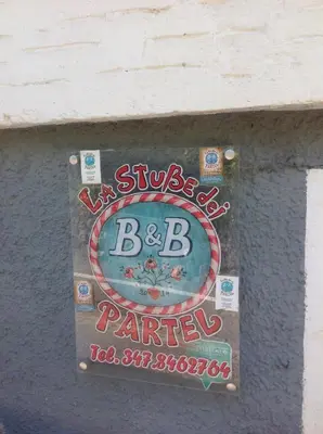 a sign on the side of a building at BeB LA STUBE DEI PARTEL in Ziano di Fiemme