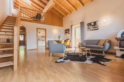 a living room with a couch and a staircase at Ferienwohnungen Wiesbauer in Schenna