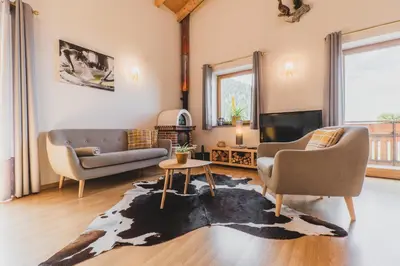 a living room with a couch and a tv at Ferienwohnungen Wiesbauer in Schenna