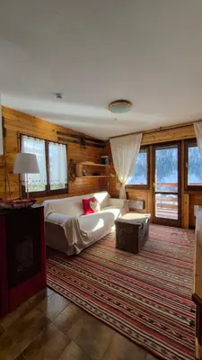 a large bedroom with a bed and a rug at AF Casa Vacanze in Campitello di Fassa