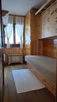 a bedroom with a bed and a window at AF Casa Vacanze in Campitello di Fassa