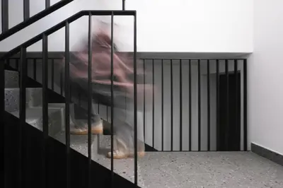 a person is walking down the stairs at Kreuz Appartement in Rifiano