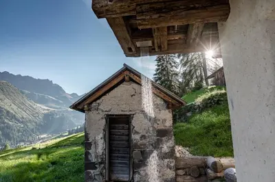 an old house on a hill with a view at Chalet Lumiere by Elite Villas in Livinallongo del Col di Lana
