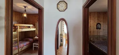a hallway leading to a bedroom with bunk beds and a mirror at Casa Scacciapensieri in Pera