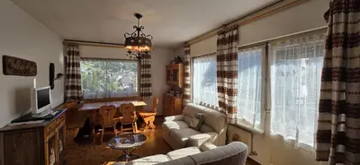 a living room with a couch and a table and windows at Casa Scacciapensieri in Pera