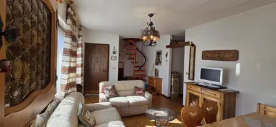 a living room with a couch and a tv at Casa Scacciapensieri in Pera