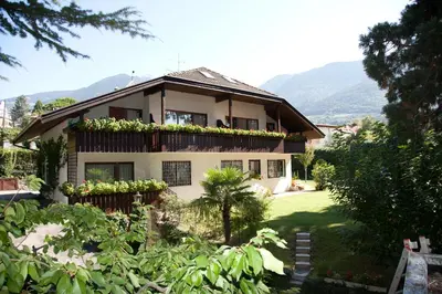 a house with a balcony with plants on it at Living Apartments Morgenstern in Merano