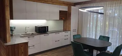 a kitchen with a table and chairs and a dining room at Chalet Radola in Campitello di Fassa