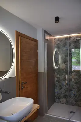 a bathroom with a shower with a toilet and a sink at Chalet Radola in Campitello di Fassa