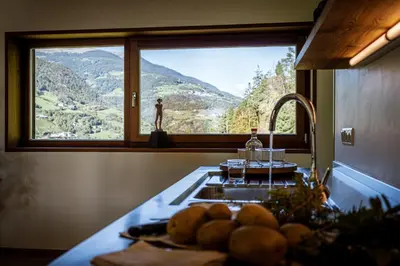 a kitchen with a sink and a window with a view at LA FUNDNEYT art & guesthouse in Laion