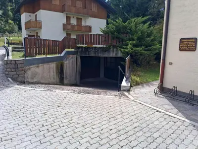 a building with a tunnel in front of a building at Casa Tullia by Go New Location in Ziano di Fiemme