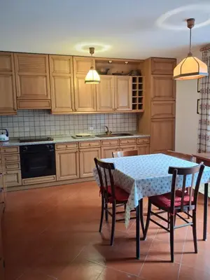 a kitchen with a table and chairs in a kitchen at Casa Tullia by Go New Location in Ziano di Fiemme