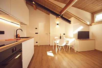 a kitchen and dining room with a table and chairs at Guest House Dezulian in Castello di Fiemme