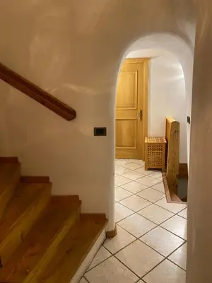 a hallway with stairs and a door in a house at Ciasablè in Fondo