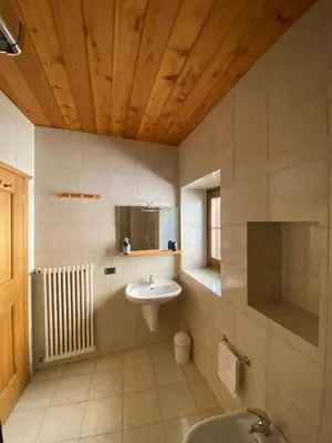 a bathroom with a sink and a toilet in it at Ciasablè in Fondo