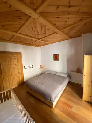 a bedroom with a bed and a wooden ceiling at Ciasablè in Fondo