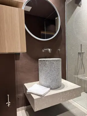 a bathroom with a sink and a mirror at La Maison 35 - Bruneck - zentral gelegene Appartments in Brunico