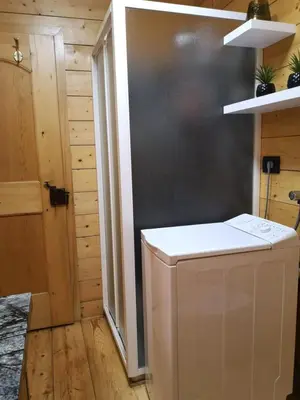 a kitchen with a washing machine in a room at Casa Angelica by Sunhome Fiemme in Varena