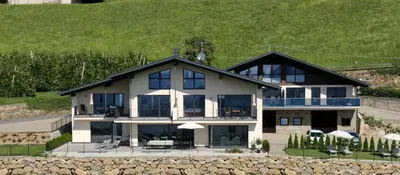 a large white house with a black roof at Appartements Laimer in Haslach in Tirolo