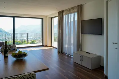 a living room with a table and a large window at Appartements Laimer in Haslach in Tirolo