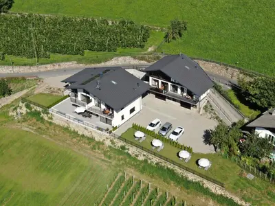 an aerial view of a large house with a yard at Appartements Laimer in Haslach in Tirolo