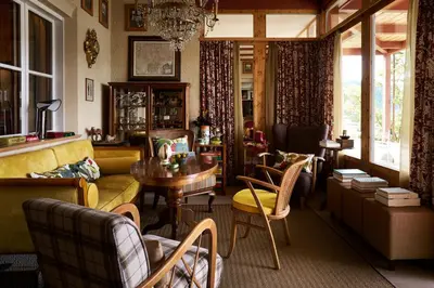 a living room with a couch and a table and chairs at Berghoferin Fine Hotel & Hideaway in Redagno