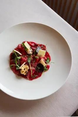 a plate of food on a white plate on a table at Berghoferin Fine Hotel & Hideaway in Redagno