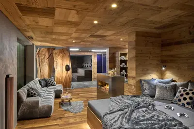 a living room with a bed and a couch at Chalet Altera by Elite Villas in Ortisei