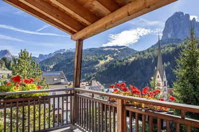 a balcony with a view of the mountains at Mayr Natur Apartments in Santa Cristina in Val Gardena