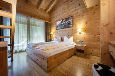 a bedroom with a bed in a wooden room at Mayr Natur Apartments in Santa Cristina in Val Gardena