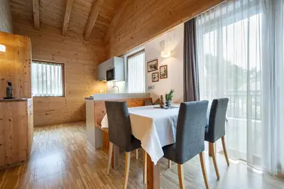 a kitchen and dining room with a table and chairs at Mayr Natur Apartments in Santa Cristina in Val Gardena