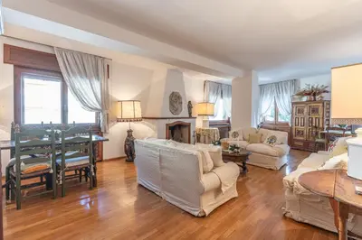 a living room with white furniture and a fireplace at Casa Bigontina 19, in the center of Cortina in Cortina dʼAmpezzo