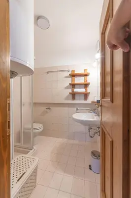 a bathroom with a sink and a toilet at Casa De Zeto, con balcone e vicina al centro in Cortina dʼAmpezzo