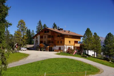 a house on a hill with a winding road at Chalet Frapes in San Martino in Badia